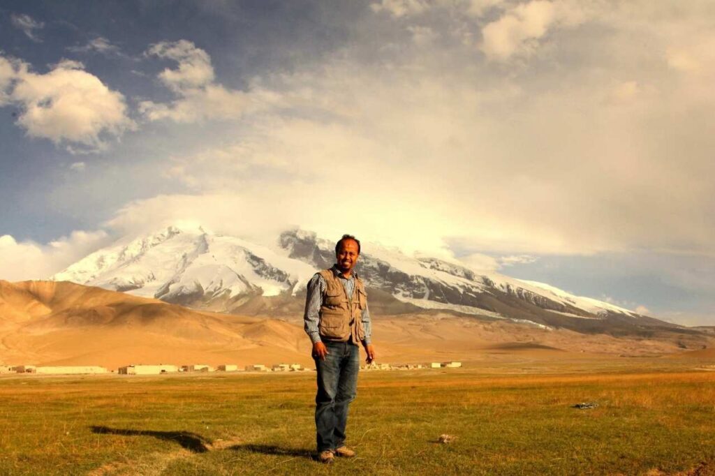 Picture of Karrar Haider with Muztagh ATA in background which is 7546 meters